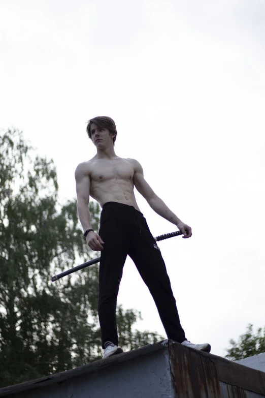 a man standing on top of a roof holding a pole, inspired by Alexander Kanoldt, cai xukun, holding a black katana, andrea savchenko, fullbody photo