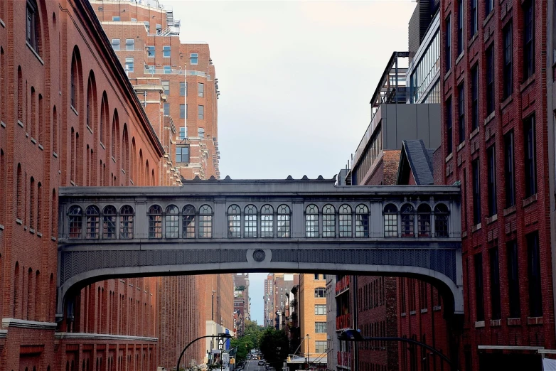 a bridge over a city street next to tall buildings, a picture, pexels, art nouveau, new york back street, train, above side view, perfect detail