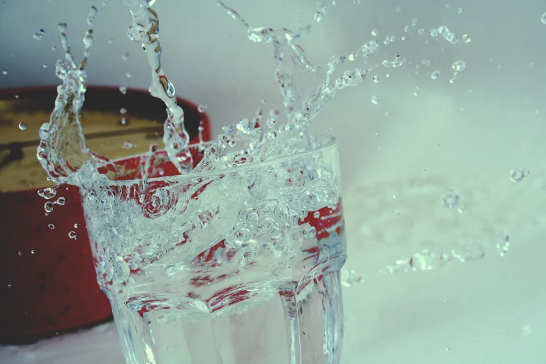 a glass with water splashing out of it, pexels, hyperrealism, closeup of magic water gate, shot with a arriflex 35 ii, retro effect, stock photo