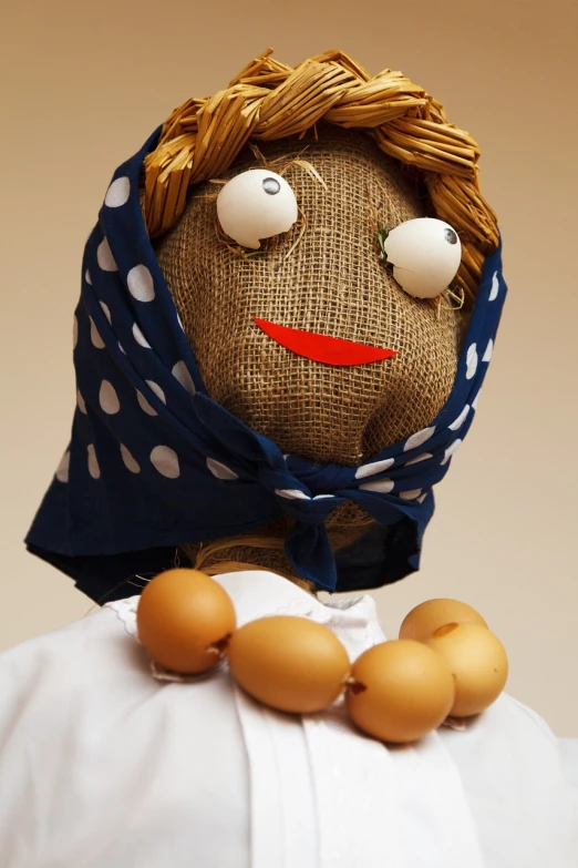 a close up of a doll with eggs on a table, a character portrait, inspired by Károly Patkó, folk art, powerful male scarecrow, woman, benjamin vnuk, egypt