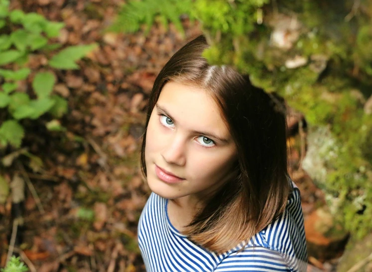 a young girl poses for a picture in the woods, a picture, by Maksimilijan Vanka, flickr, realism, headshot photo, she is about 1 6 years old, high angle closeup portrait, 1 / 4 headshot