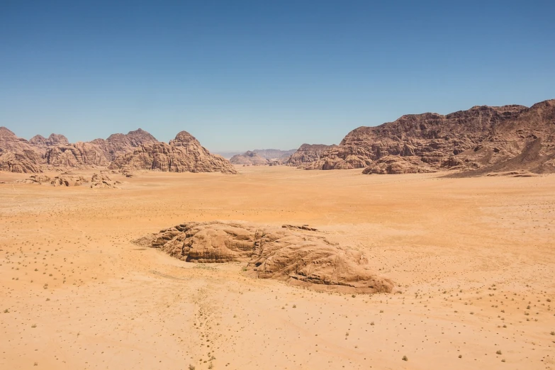 a large rock in the middle of a desert, pexels, les nabis, from 1 0 0 0 feet in distance, very wide wide shot, jordan, red!! sand