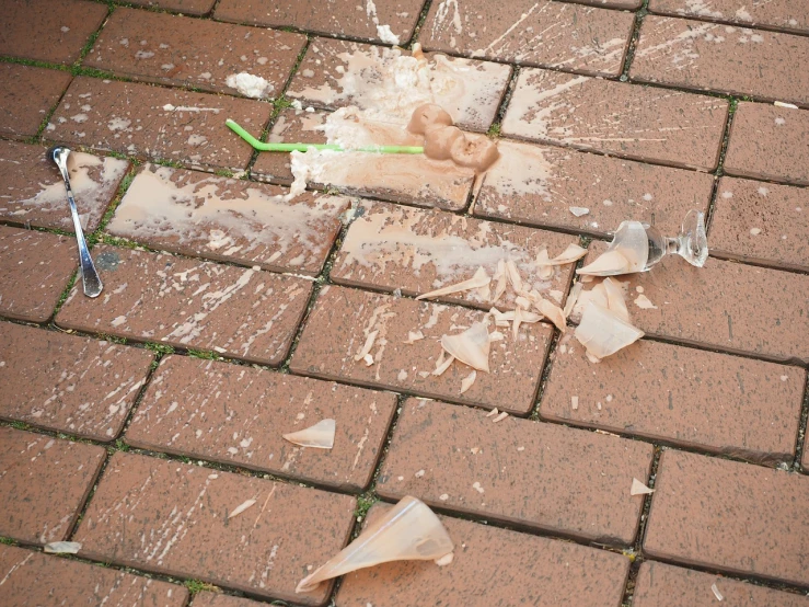 a broken toothbrush sitting on top of a brick floor, a picture, by Jan Kupecký, shutterstock, happening, raining glass shards, sidewalk, stock photo, ground explosion