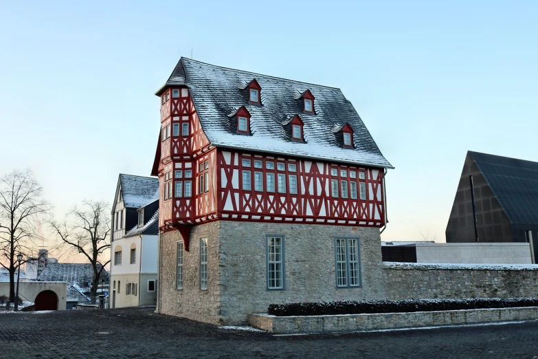 a red and white building sitting on the side of a road, inspired by Matthias Jung, flickr, medieval house, detmold charles maurice, january, truss building