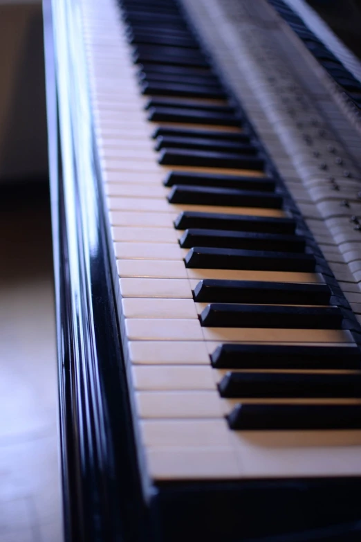 a close up of a black and white piano keyboard, in a medium full shot, indoor shot, [ [ hyperrealistic ] ], high details photo