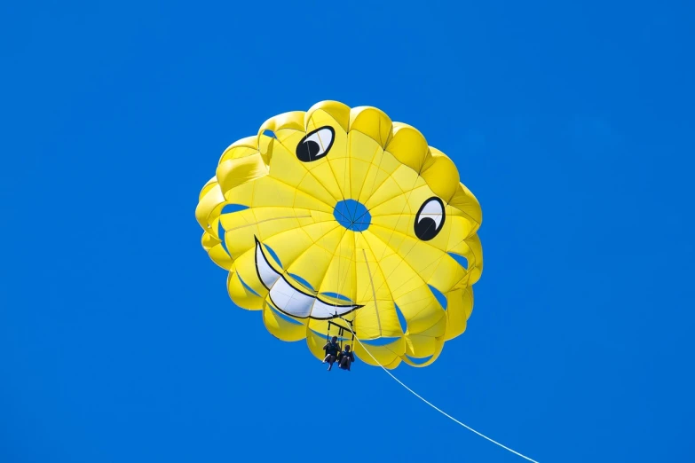 a yellow parachute with a smiley face on it, by Hiromu Arakawa, shutterstock, gondola, symmetric!!, spitfire, 1 6 9 5