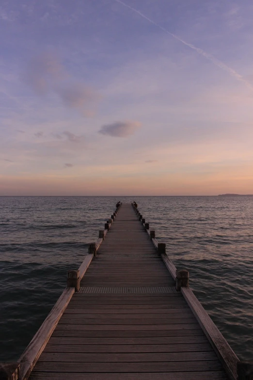 a dock stretching out into the ocean at sunset, a picture, by Holger Roed, long view, leading to a beautiful, gray, beautiful wallpaper