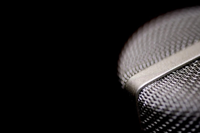 a close up of a microphone with a black background, a macro photograph, by Andrew Domachowski, flickr, banner, depth of field”, shaded, soft volumetric studio lighting