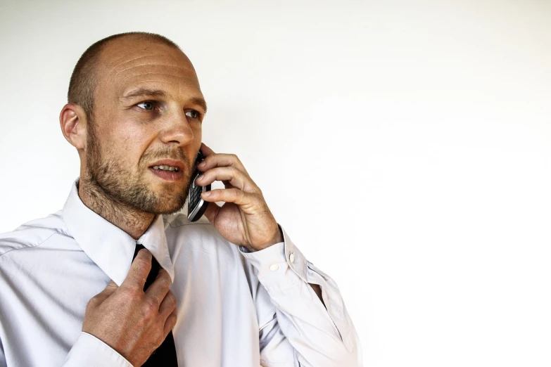 a man in a white shirt and tie talking on a cell phone, a photo, figuration libre, beskinski, bald man, high - key, maintenance