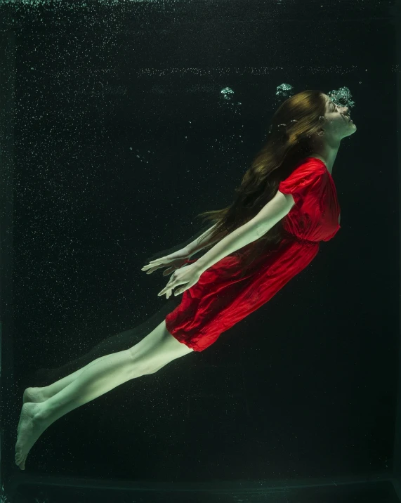 a woman in a red dress swims under water, a hyperrealistic painting, art photography, vertical portrait, azamat khairov, photo taken with sony a7r, 2 0 1 4