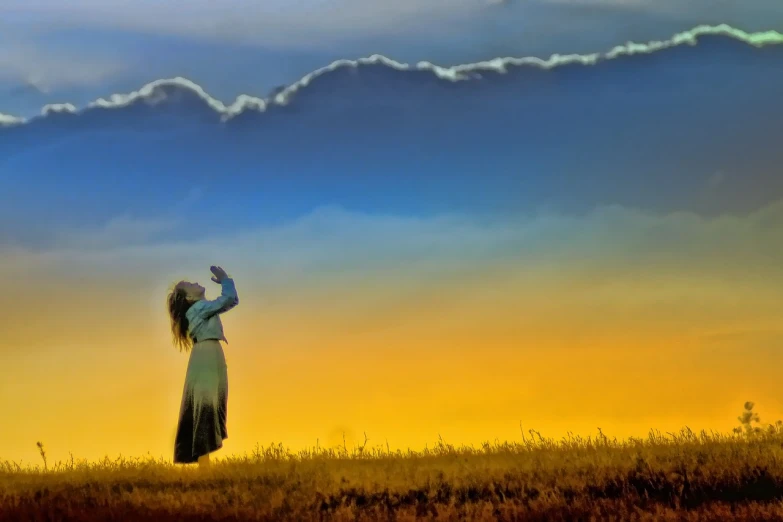 a woman standing on top of a grass covered field, inspired by Tom Chambers, precisionism, blue - yellow sky, waving, enhanced photo, praying