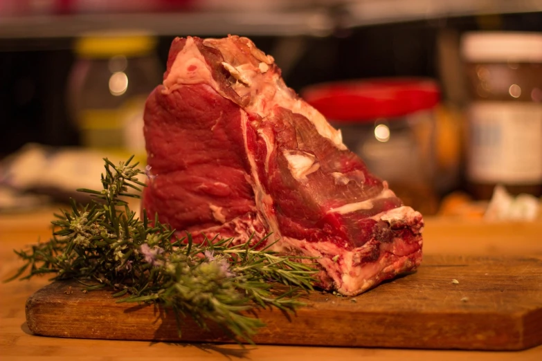 a piece of meat sitting on top of a cutting board, by Julian Hatton, bull head, white neck visible, recipe, high quality upload