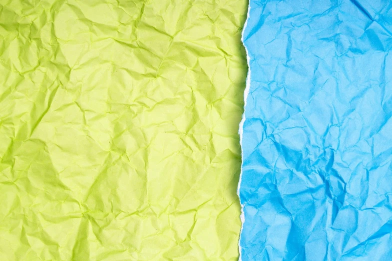 a couple of pieces of paper sitting next to each other, a stock photo, color field, close up portrait photo, some yellow green and blue, paper crumpled texture, uncompressed png
