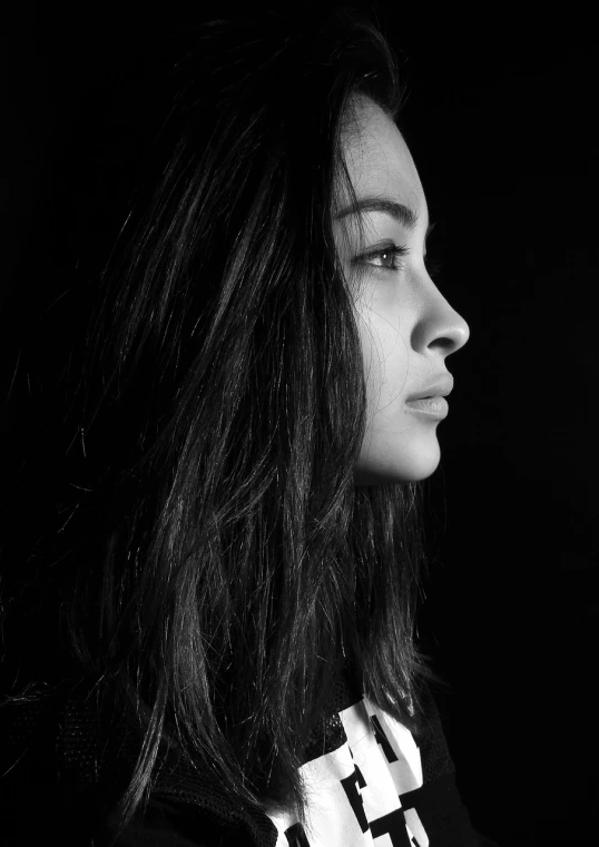a black and white photo of a woman with long hair, a black and white photo, by Adam Marczyński, pexels, side portrait of a girl, young middle eastern woman, noseless, a woman's profile