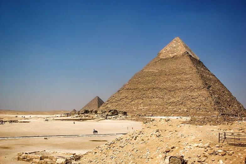 a large pyramid sitting in the middle of a desert, egyptian art, pexels, fine art, twins, the see horse valley, sweeping vista, high detail photo of a deserted