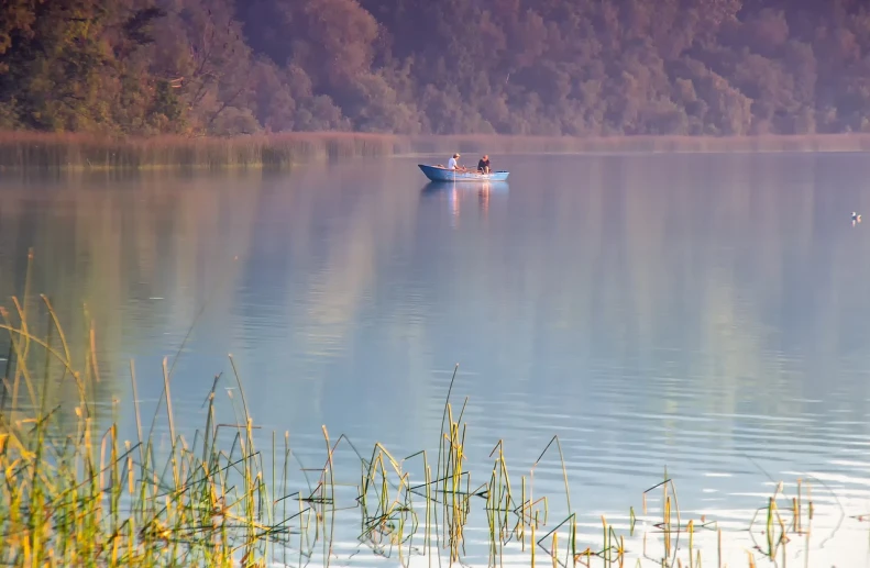 a couple of people in a small boat on a lake, a picture, by Istvan Banyai, shutterstock, soft morning light, fishing, october, version 3