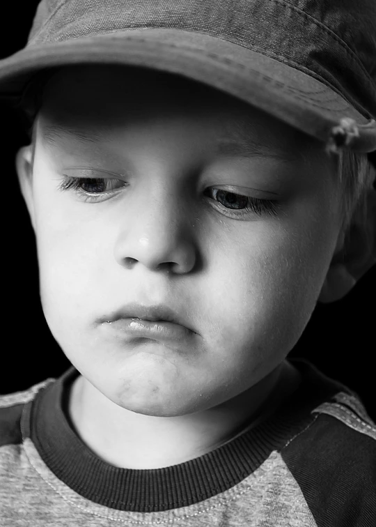 a close up of a child wearing a hat, a picture, inspired by Jan Rustem, pixabay, he has a devastated expression, b & w detailed sharp photo, blond boy, istockphoto