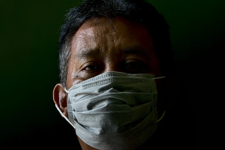 a close up of a person wearing a face mask, a portrait, by Joze Ciuha, flickr, sumatraism, medical photography, a photo of a man, stock photo, with backlight