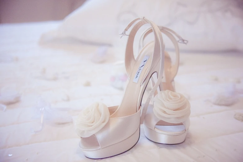 a close up of a pair of shoes on a bed, a picture, tumblr, romanticism, white roses, charlize, exquisite detail, white details