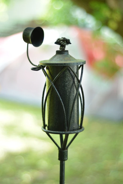 a bird feeder sitting on top of a metal pole, art nouveau, royal green and nature light, studio microphone, close-up product photo, celebration