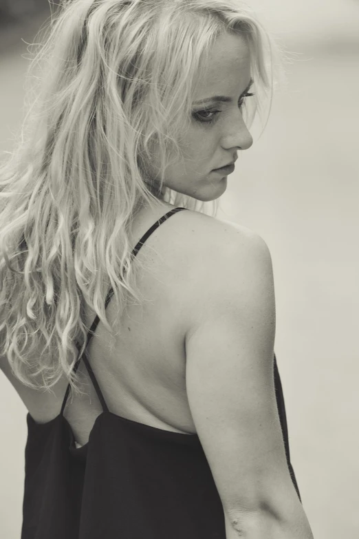 a black and white photo of a woman with long hair, a black and white photo, inspired by Peter Lindbergh, bare back, evanna lynch, 8k 50mm iso 10, succubus in sundress portrait