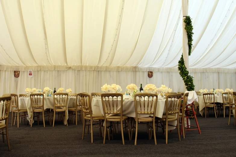 a room filled with lots of tables and chairs, shutterstock, renaissance, tent, white with gold accents, mid shot photo, seams