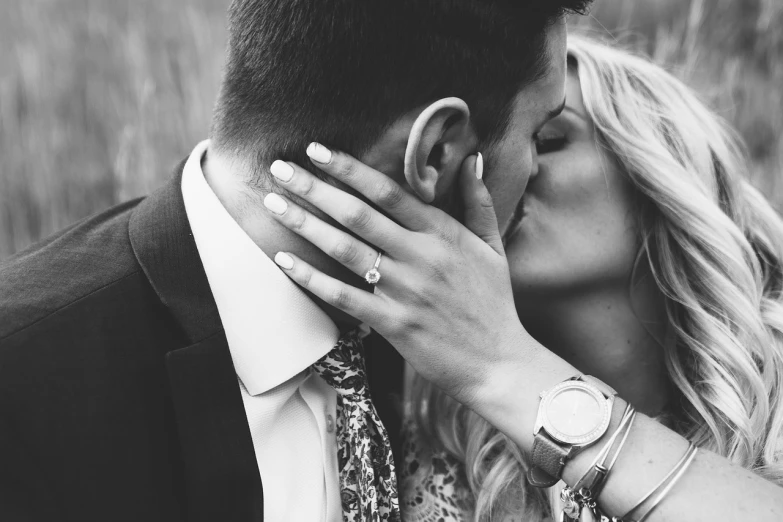 a black and white photo of a man kissing a woman, by Matija Jama, pexels, ring flash closeup photograph, man proposing his girlfriend, no words 4 k, holding his hands up to his face