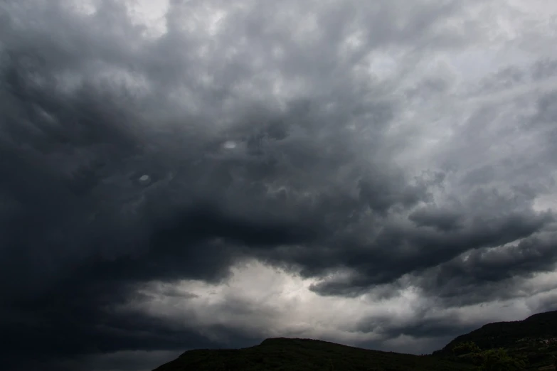 a person flying a kite under a cloudy sky, romanticism, dark mammatus cloud, marsden, taken with my nikon d 3, looking threatening