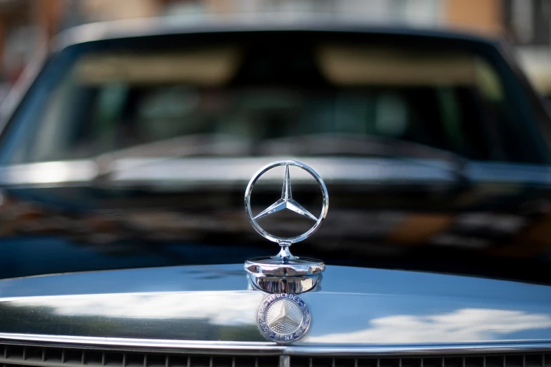 a close up of a car hood ornament, a picture, by Etienne Delessert, shutterstock, mercedez benz, viewed from very far away, ceremonial, stock photo