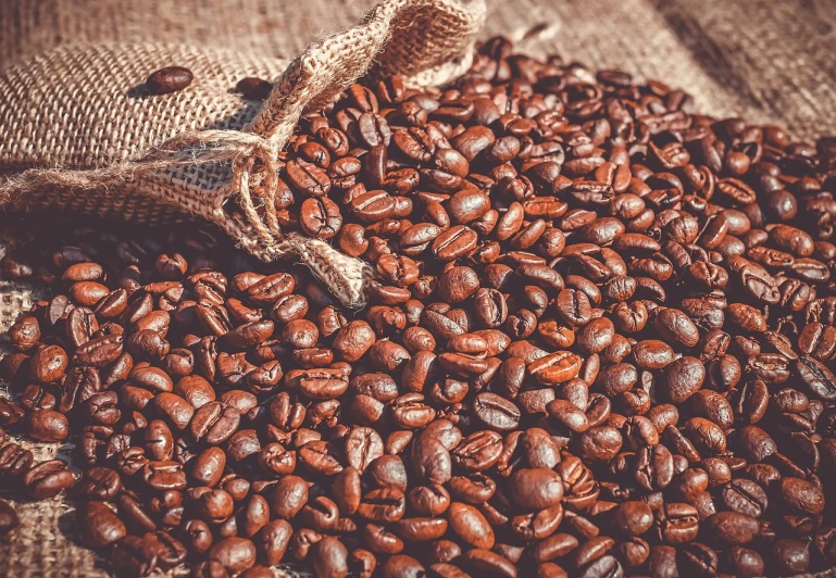a sack of coffee beans sitting on top of a table, by Julian Hatton, pexels, beautiful sunny day, hyperdetailed!!, brown colours, vivid and vibrant