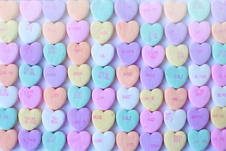 a bunch of candy hearts sitting on top of a table, a picture, dlsr photo, close up details, lovercraft, sugar