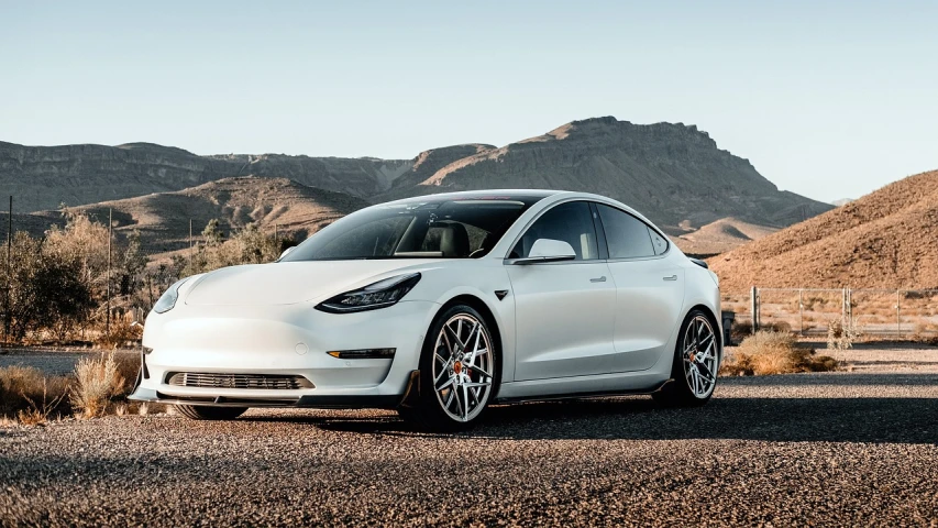 a white tesla model 3 parked on the side of the road, a portrait, by Austin English, renaissance, white wheel rims, 1 2 k, chrome and carbon, on the desert