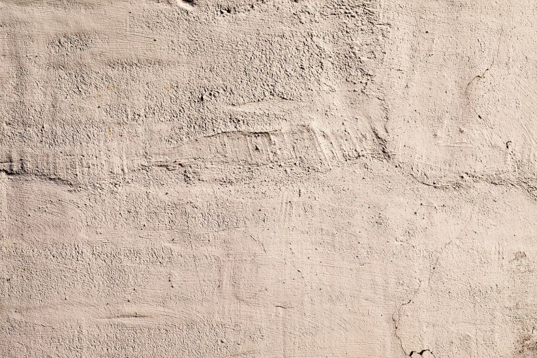 a man riding a skateboard on top of a cement wall, a portrait, inspired by Lucio Fontana, concrete art, detail texture, sandy beige, 1811, foundation