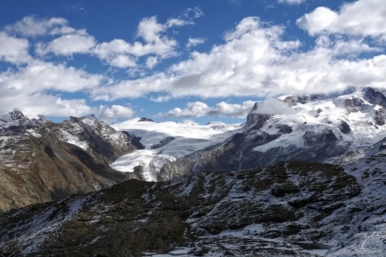 a group of people standing on top of a snow covered mountain, a portrait, by Werner Andermatt, pexels, hurufiyya, with clouds in the sky, glacier landscape, with highly detailed, a beautiful mine