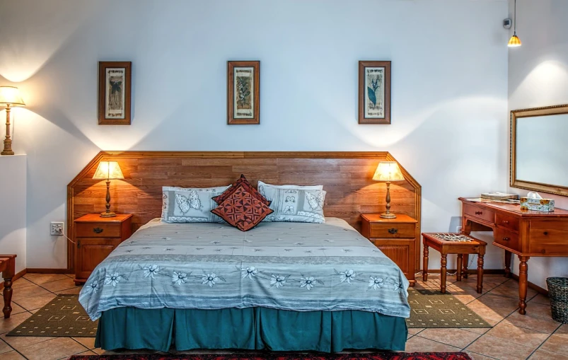 a bed room with a neatly made bed, a stock photo, by Alexander Bogen, shutterstock, fine art, decorated polished wood, low ceiling, colour corrected, colonial style