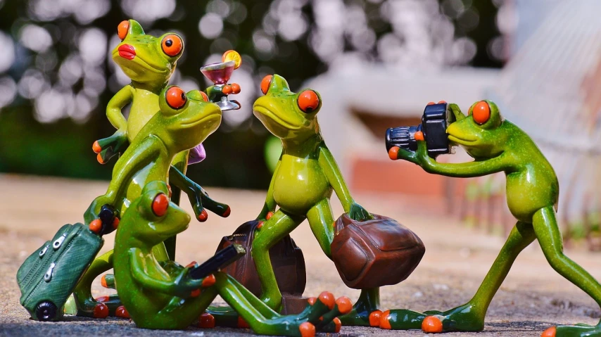 a group of frog figurines sitting next to each other, a picture, by Zoran Mušič, pexels, visual art, dabbing, drinking, camera photo, wide screenshot