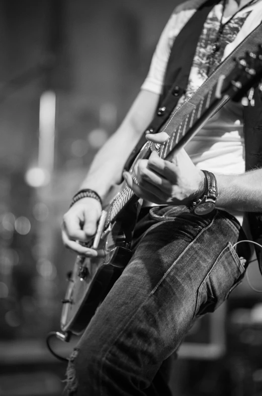 a black and white photo of a man playing a guitar, pexels, realism, heavy rock concert, istockphoto, dsrl photo, a wide shot