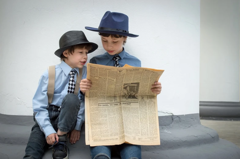 a couple of young boys sitting next to each other, by Zofia Stryjenska, pixabay, modernism, newspaper picture, blue fedora, dressed like in the 1940s, stock photo