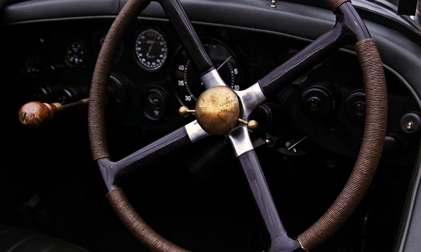 a close up of a steering wheel on a car, by David Simpson, auto-destructive art, vintage aston martin, steampunk aesthetic, simple, wallpaper mobile