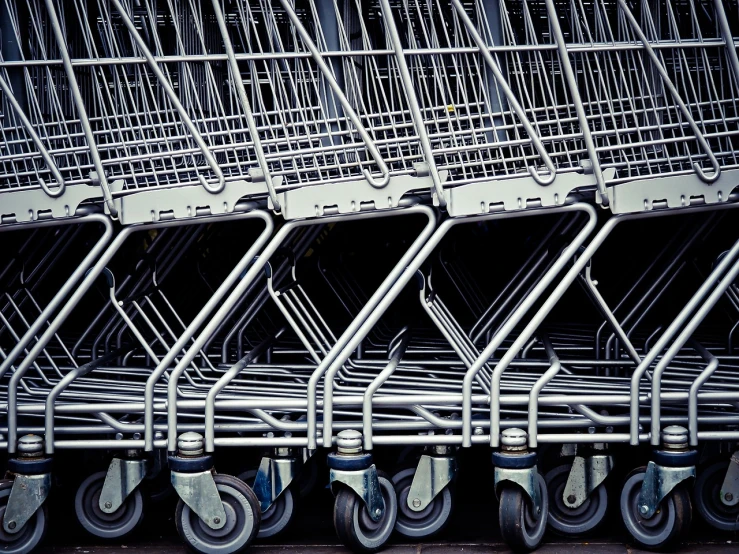 a row of shopping carts sitting next to each other, by Armin Hansen, precisionism, photorealism. trending on flickr, 🎨🖌️, sharp lines, seattle