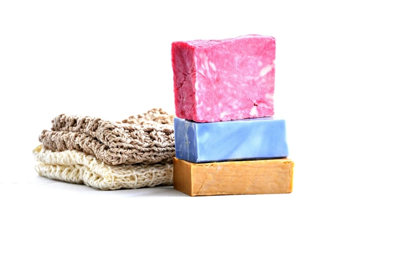 three soap bars stacked on top of each other, rags, chemicals, product photo