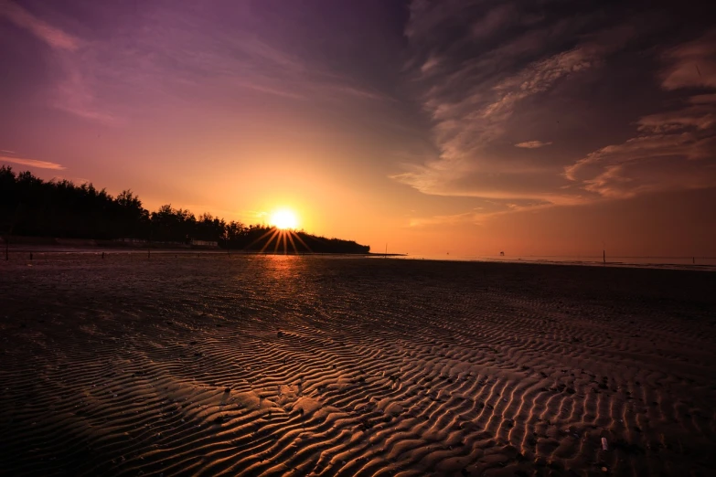 the sun is setting over a sandy beach, a picture, by Basuki Abdullah, shutterstock, heat ripples, hdr smooth, night setting, very beautiful photo