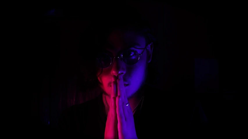 a woman talking on a cell phone in the dark, inspired by Nan Goldin, holography, synthwave colors!!, praying with tobacco, wearing red tainted glasses, blacklight aesthetic