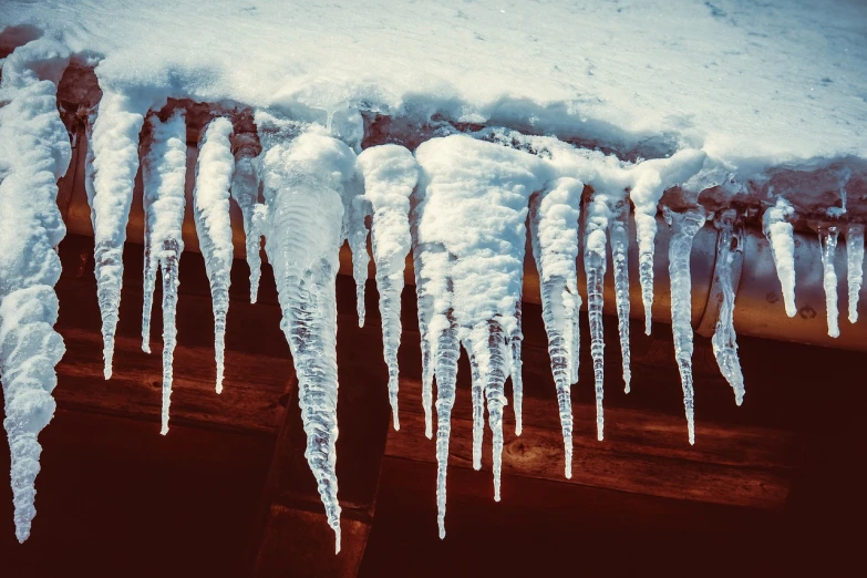 icicles hanging from a roof in the snow, inspired by Elsa Bleda, incoherents, retro effect, swamp monster of ice, peaked wooden roofs, an ice volcano
