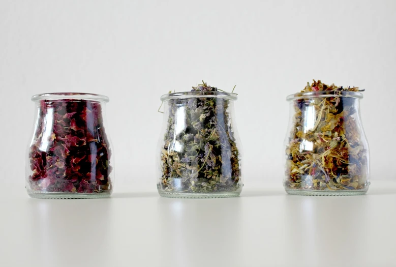 three glass jars filled with different types of herbs, by Matija Jama, process art, 2 1 st century, flower petals, marina abramovic, panoramic