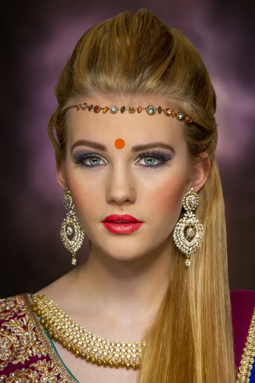 a close up of a woman with long hair, a colorized photo, by Wayne England, trending on cg society, hindu ornaments, blonde beautiful young woman, with professional makeup, face accessories