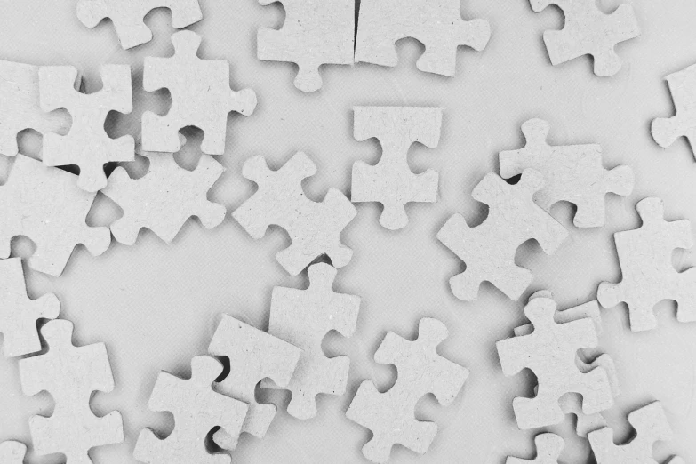 a pile of puzzle pieces sitting on top of a table, a jigsaw puzzle, by Eugeniusz Zak, pexels, visual art, ambient occlusion:3, 1024x1024, white concrete, iphone wallpaper