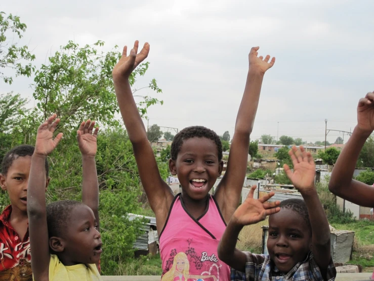 a group of children standing next to each other, by Hubert van Ravesteyn, happening, waving and smiling, she is happy, surrounding the city, rosen zulu