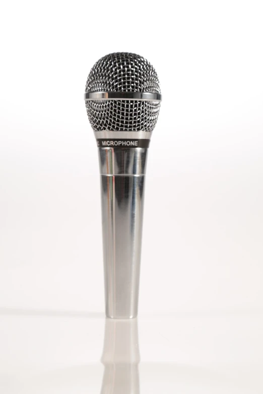 a microphone sitting on top of a table, highly detailed product photo, silver, miniature product photo, f4”