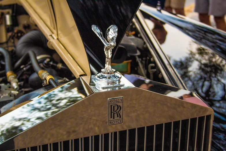 a close up of a hood ornament on a car, by Raymond Normand, renaissance, wraith, rtx engine, marbella, on display